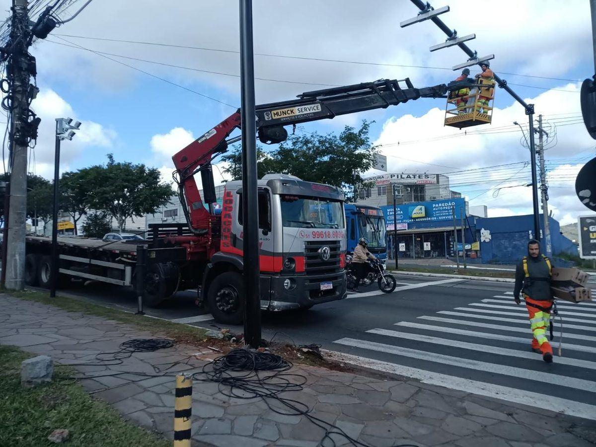Caminhão munck Construdini com cesto aéreo elevado em manutenção urbana
